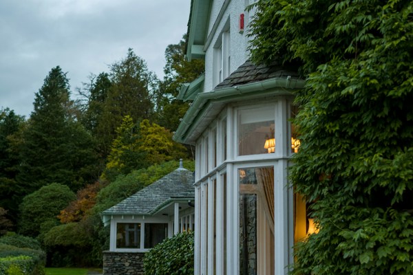 Residential family home surrounded by gardens, representing property matters following separation or divorce.