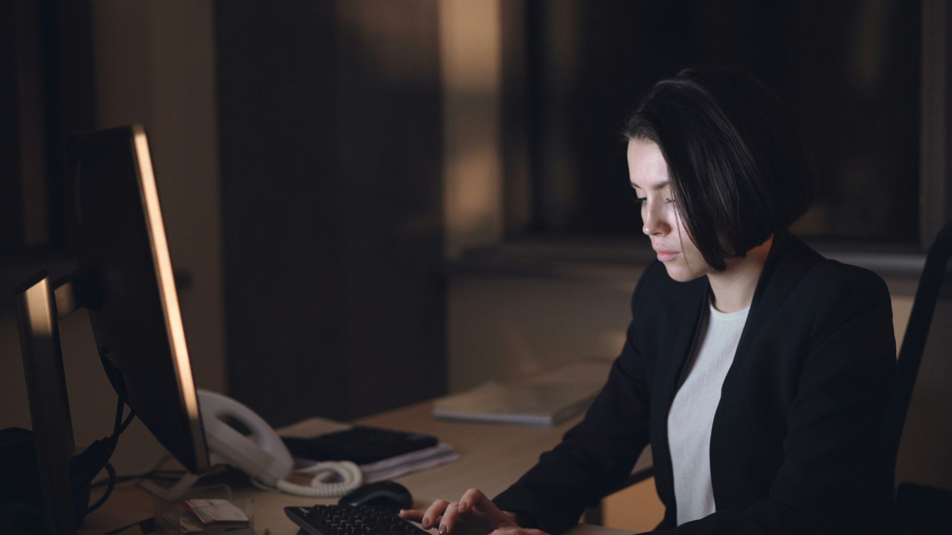 Solicitor reviewing legal documents on a computer screen, illustrating the importance of verifying AI-generated legal content.