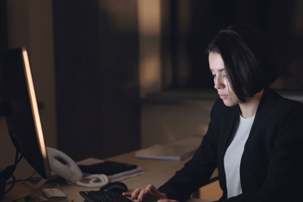 Solicitor reviewing legal documents on a computer screen, illustrating the importance of verifying AI-generated legal content.