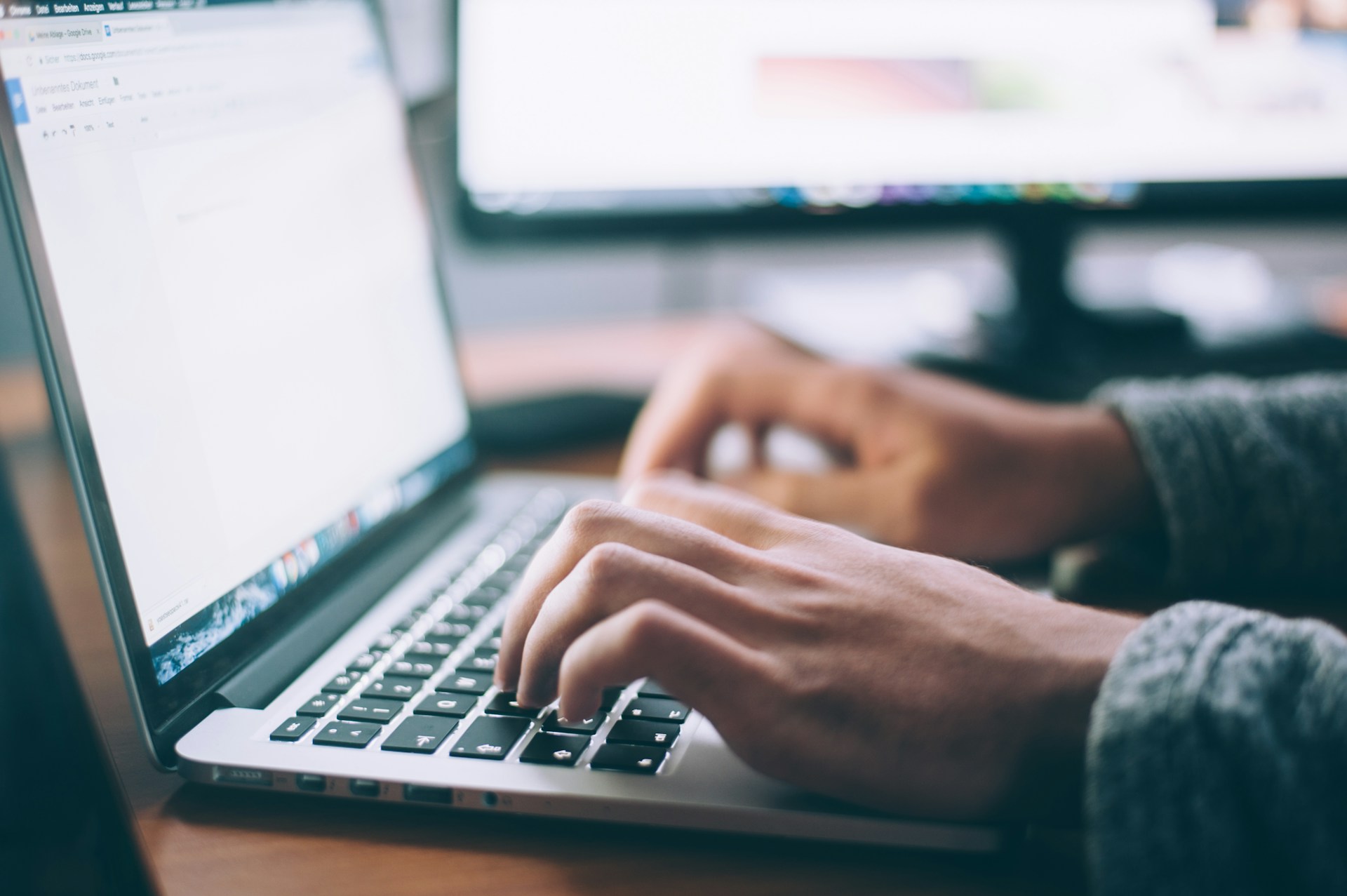 Person typing on a laptop computer, illustrating electronic communications and digital fundraising by charities.
