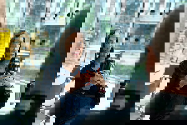 Two colleagues in discussion in a professional setting, representing confidential workplace conversations and whistleblowing processes.