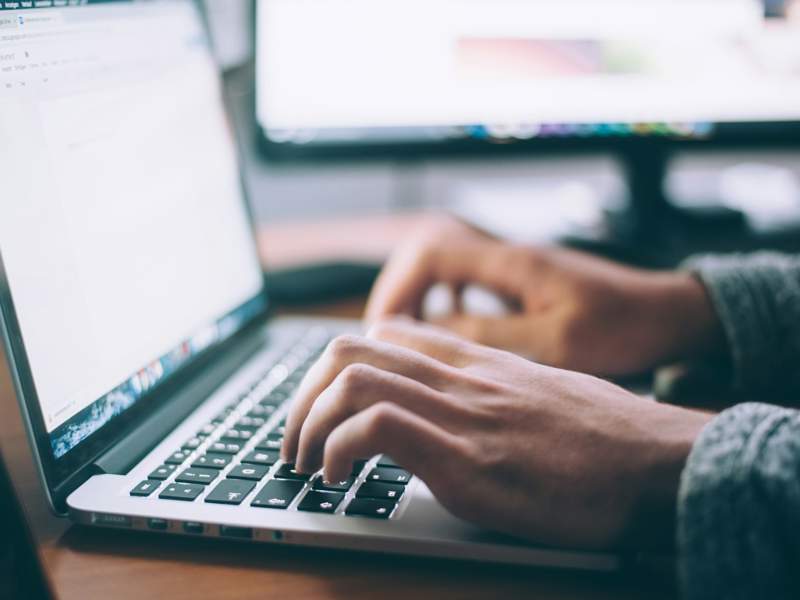 Professional using AI-assisted technology to review digital documents and information requests.
