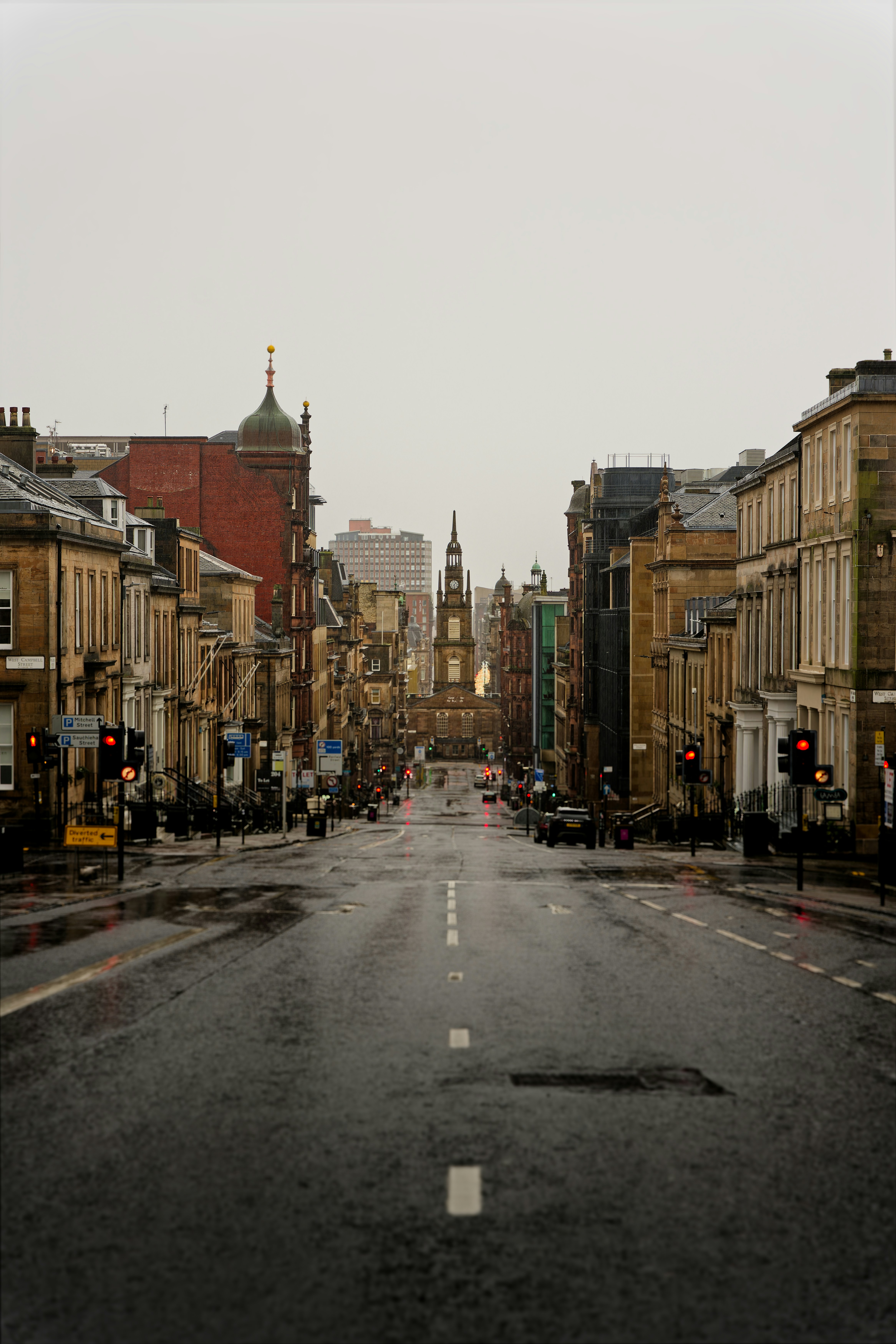 Rainy view of a UK city street with historic buildings, reflecting uncertainty in the commercial real estate market.