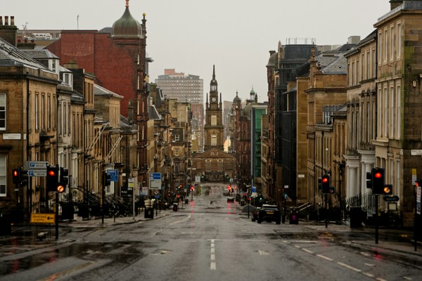 Rainy view of a UK city street with historic buildings, reflecting uncertainty in the commercial real estate market.