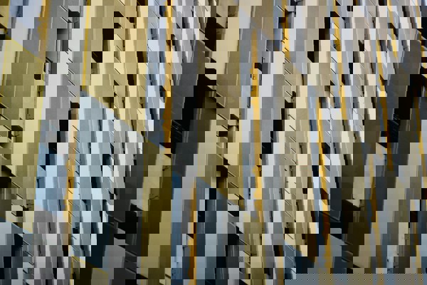 Close-up of a modern building façade featuring metal cladding panels, similar to those assessed in building safety and remediation work.