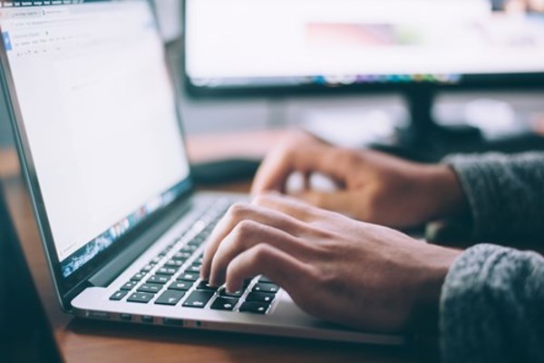 person typing on latop