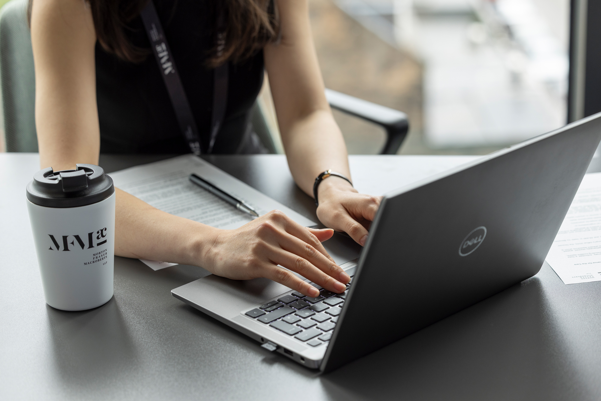 Person typing on a laptop during an employment law webinar