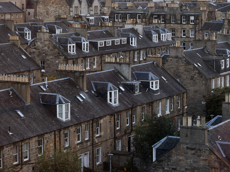 Rows of traditional Edinburgh tenement buildings in Scotland.