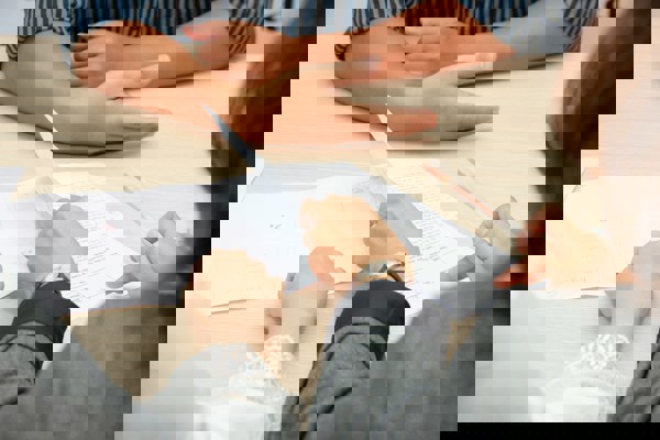 A group of professionals reviewing documents together at a meeting table.