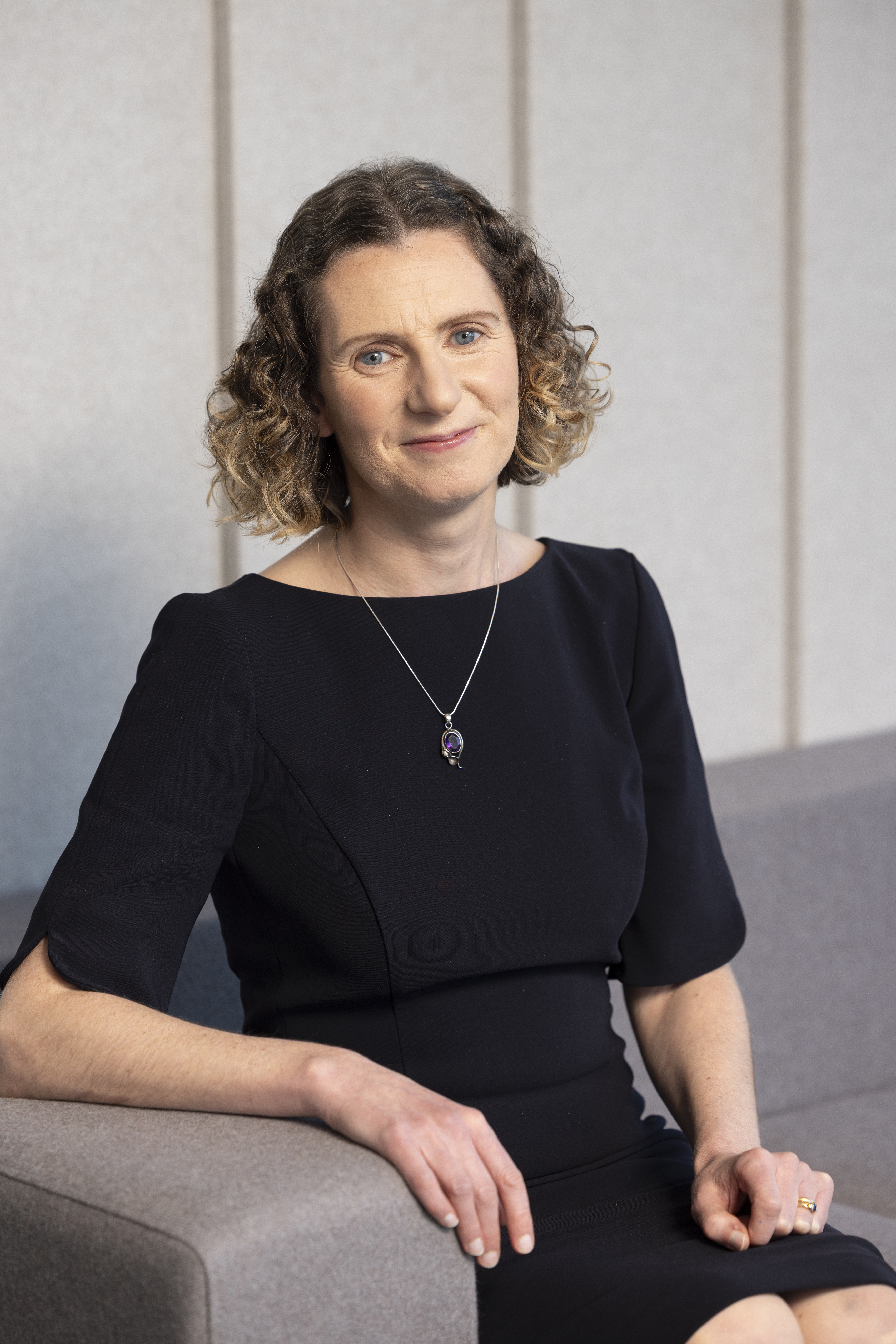 Professional portrait of family law solicitor Lucia Clark seated in an office setting.