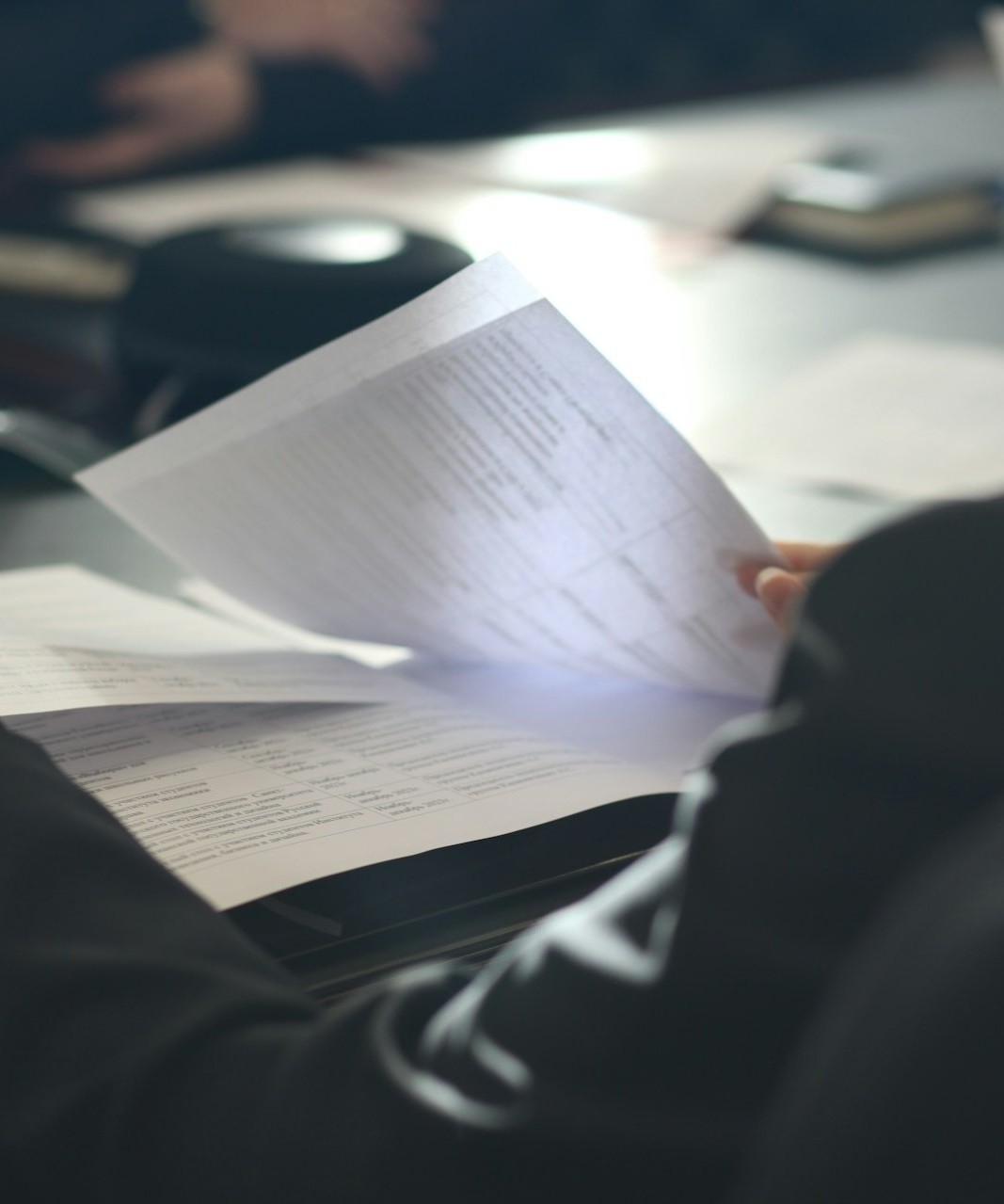 Person reviewing workplace documents during a meeting, representing employment law updates, compliance and workplace policy developments.